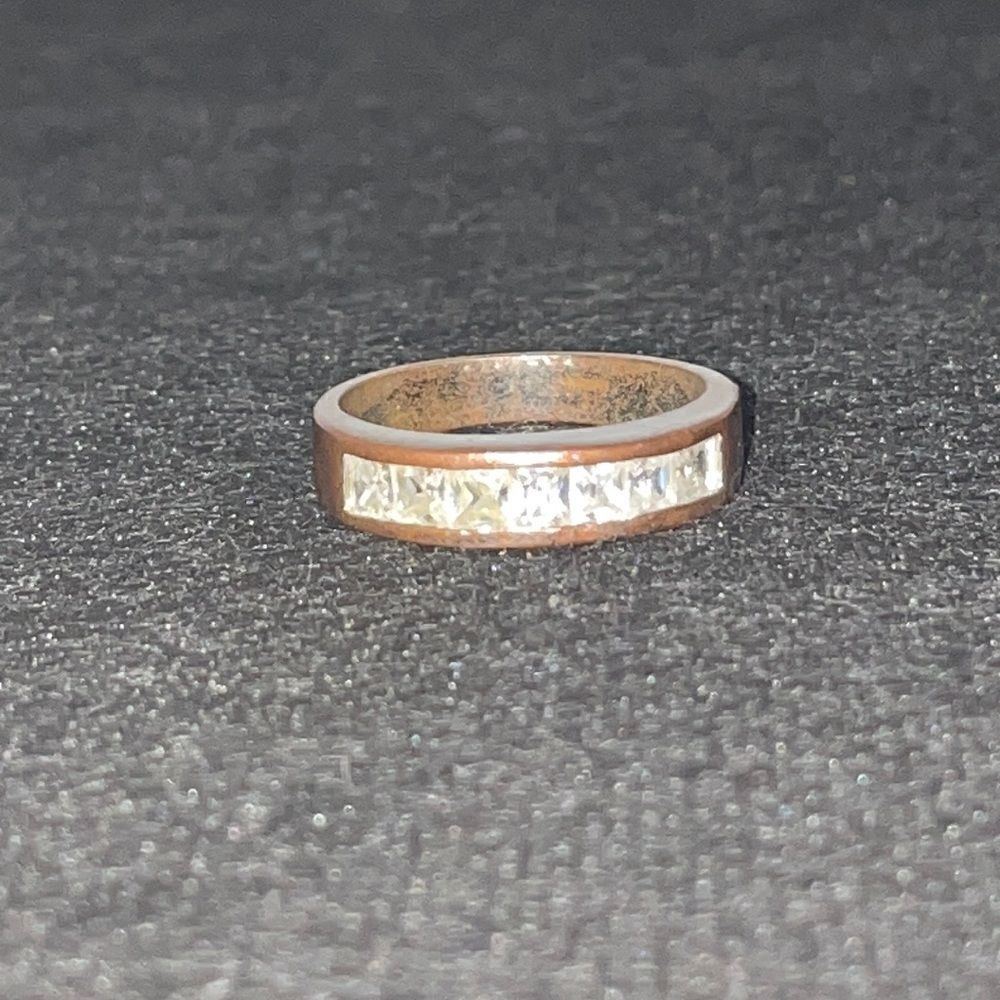 Metal ring with a row of white gems
